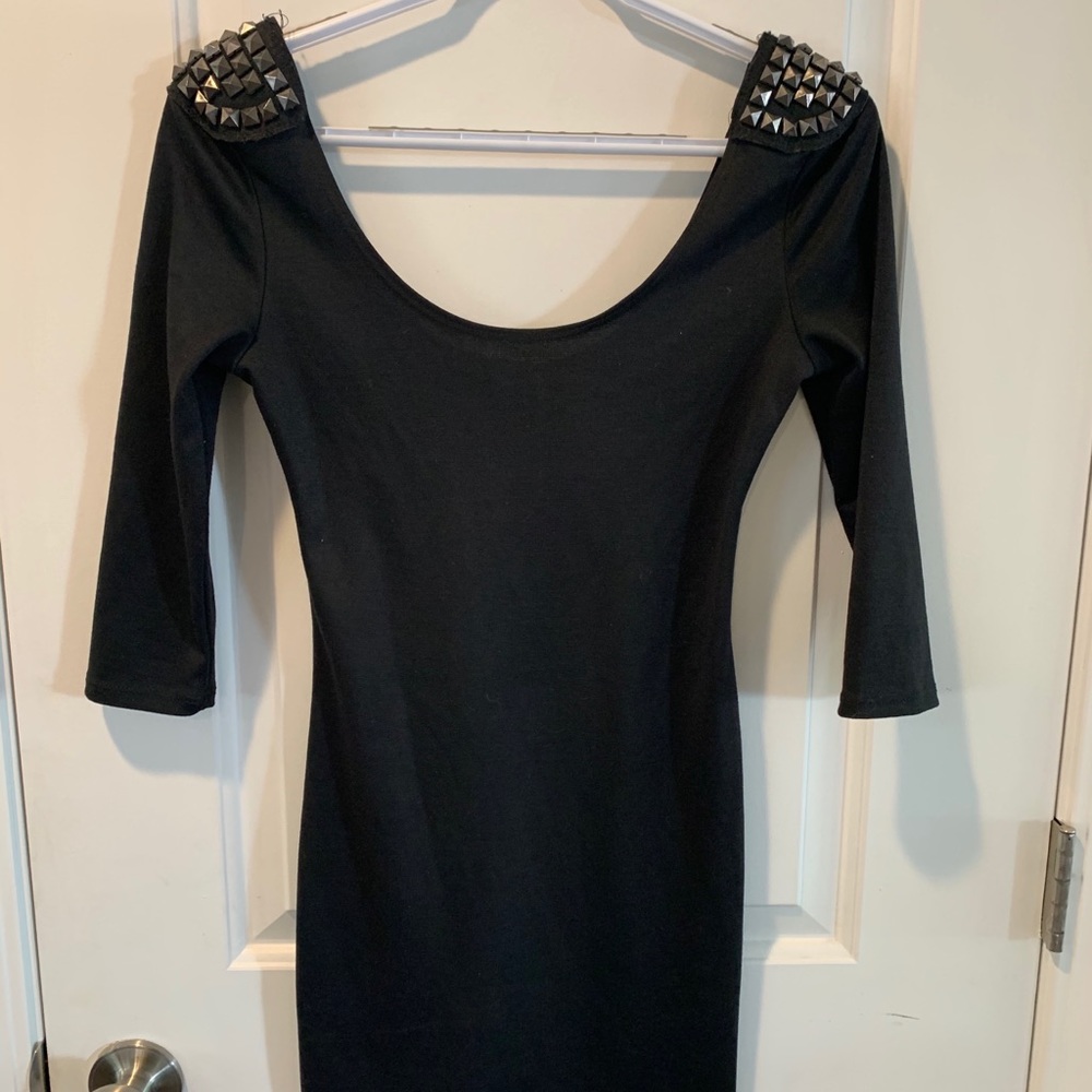 Black mini dress with studded shoulder pads